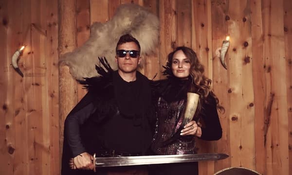 Martin Borch Jensen and Jenna Hermann in costume at an unidentified wood-paneled location